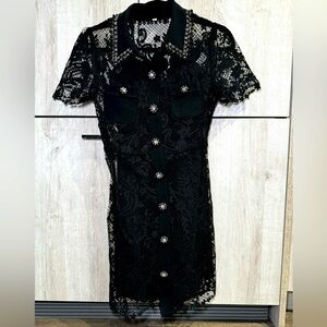 Black net dress with jeweled detail.